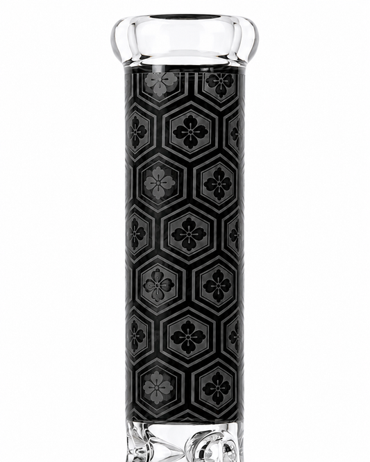 A clear glass water pipe with a black and gray geometric patterned grip, shown against a plain white background.