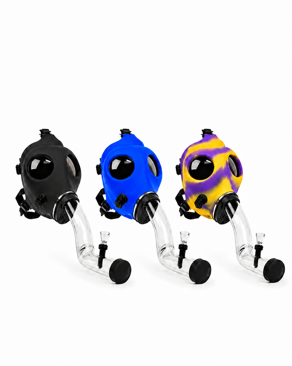 Three silicone gas mask-style accessories with clear glass bowls and stems, shown in black, blue, and yellow-and-purple patterned colors on a white background.