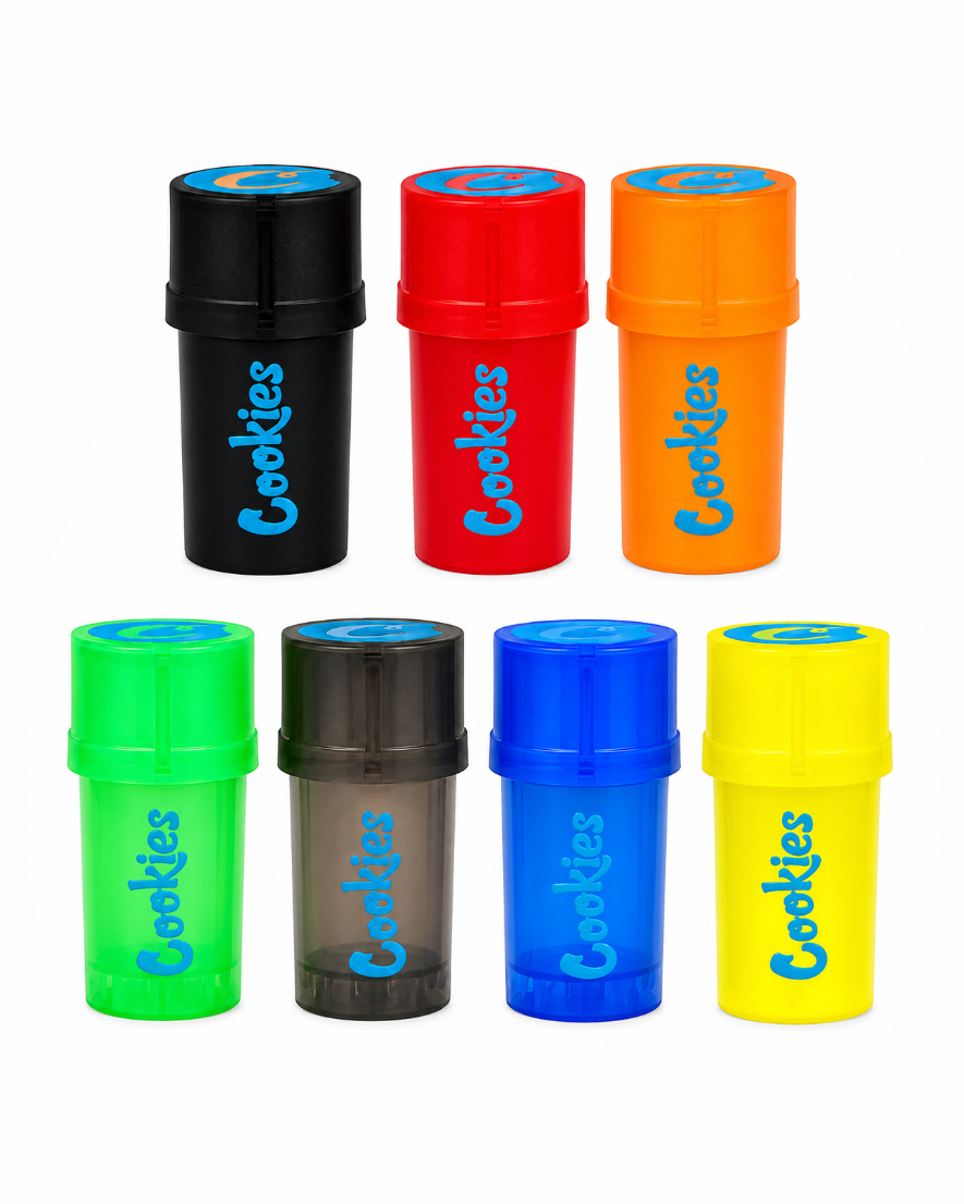 Six cylindrical plastic cookie jars in assorted colors, arranged in two rows on a plain white background. The top row contains black, red, and orange jars, and the bottom row contains green, translucent dark gray, blue, and yellow jars.
