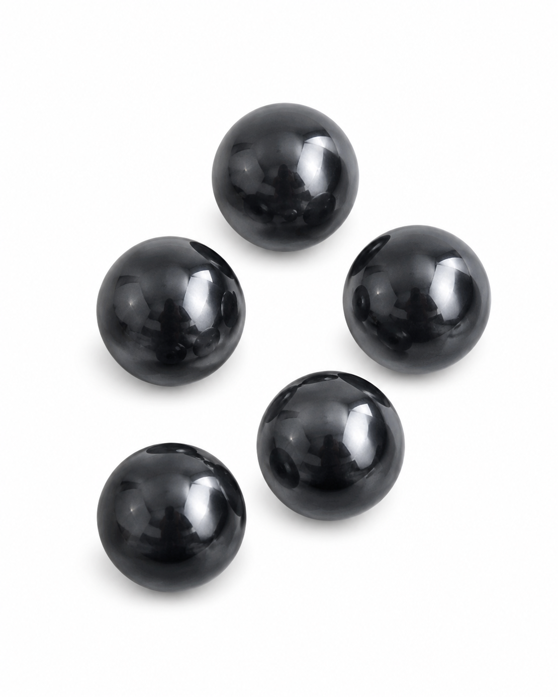 Five glossy black spherical beads arranged in a loose circle on a plain white background.