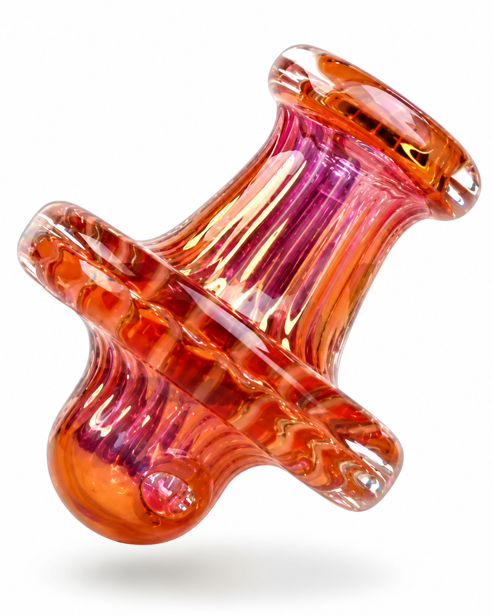 A hand-blown glass smoking accessory, likely a bowl or mouthpiece, featuring a ribbed design with a gradient of orange, red, and pink colors on a white background.