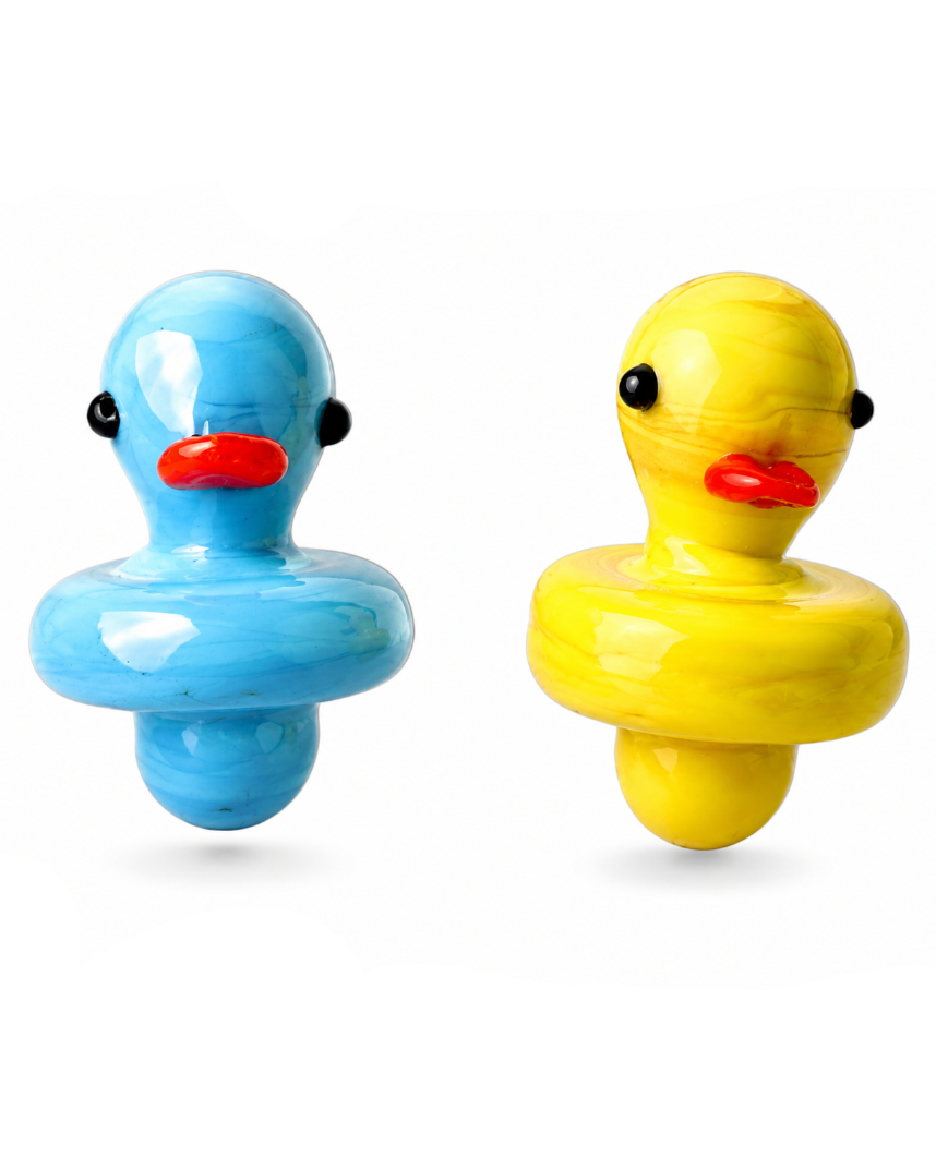 Two glossy duck-shaped spinning tops, one light blue and one bright yellow, each with a red beak and black eyes, shown on a plain white background.